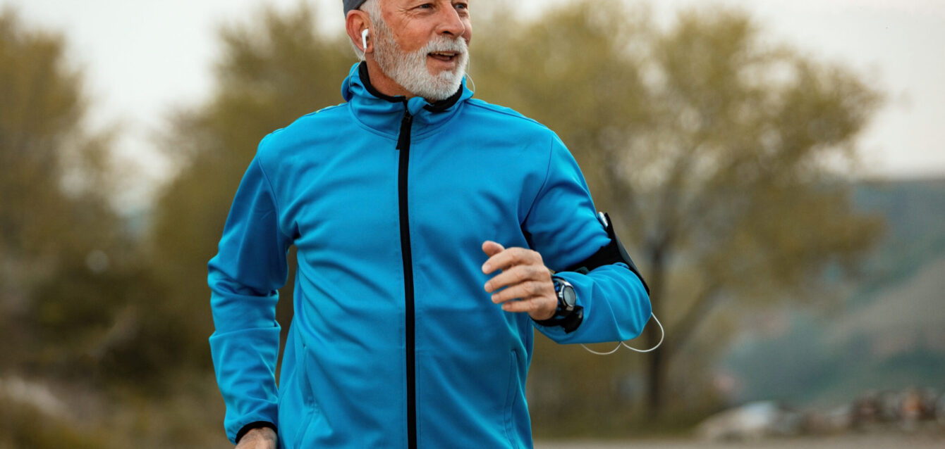 Happy senior man jogging in nature. Happy senior man jogging in nature.